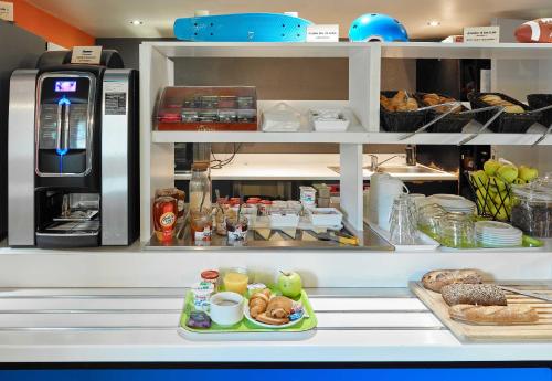 a kitchen with a plate of food on a shelf at B&B HOTEL Cergy Pierrelaye in Pierrelaye