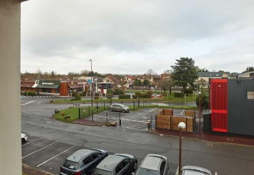 a parking lot with cars parked in a parking lot at B&B HOTEL Cergy Pierrelaye in Pierrelaye