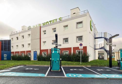 a parking lot in front of a building at B&B HOTEL Cergy Pierrelaye in Pierrelaye