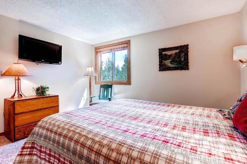 a bedroom with a bed and a tv on the wall at Ski Hill 15 by Ski Country Resorts in Breckenridge