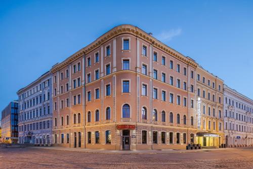 a large brick building on the corner of a street at Eurostars Metropole in Rīga