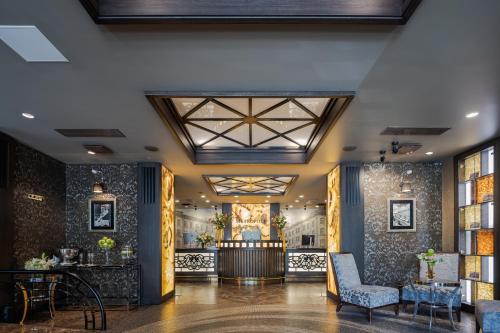 a lobby of a hotel with chairs and a table at Eurostars Metropole in Rīga