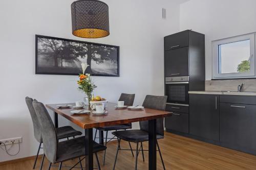 a kitchen with a dining room table and chairs at Chalet Am Ried in Bad Wurzach
