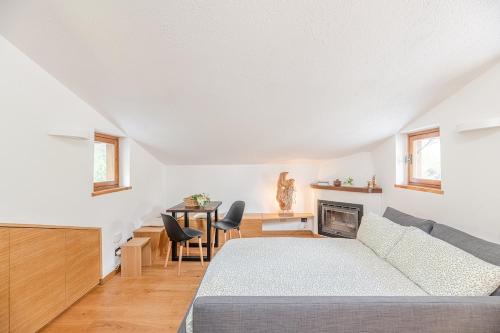 a bedroom with a bed and a table with chairs at Nest-home in front to Mont Blanc in Courmayeur