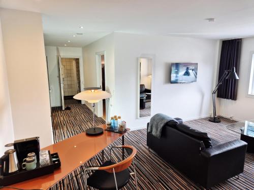 a living room with a table and a couch at Hotel Hans Egede in Nuuk