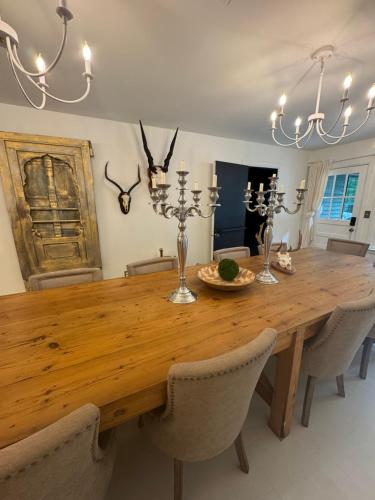 a dining room with a wooden table and chairs at J and M on Capital Boutique Guesthouse in Frankfort