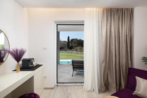 a living room with a sliding glass door at Valbrione - Luxury Rooms & Suites in Valbandon