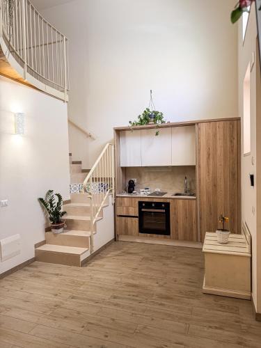 a living room with stairs and a kitchen at BONA NOVA-Puglia Living in Massafra