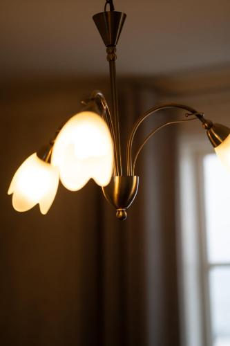 a lamp hanging from a ceiling with a window at Hótel Blönduós in Blönduós