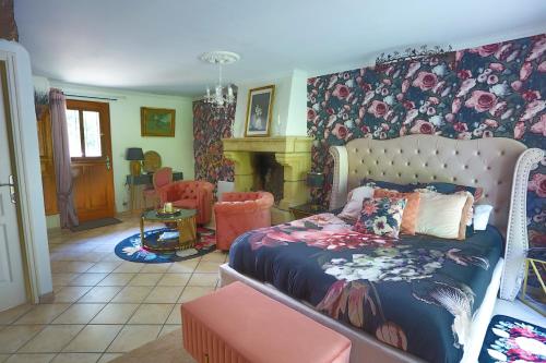 a bedroom with a bed and a fireplace at Le Clos Saint Fiacre in Carentoir