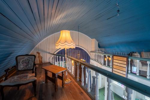 a room with a table and a lamp on a balcony at Hótel Blönduós in Blönduós