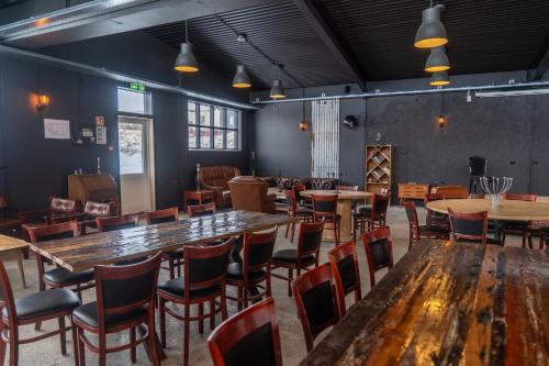 a room with tables and chairs in a restaurant at Hótel Blönduós in Blönduós