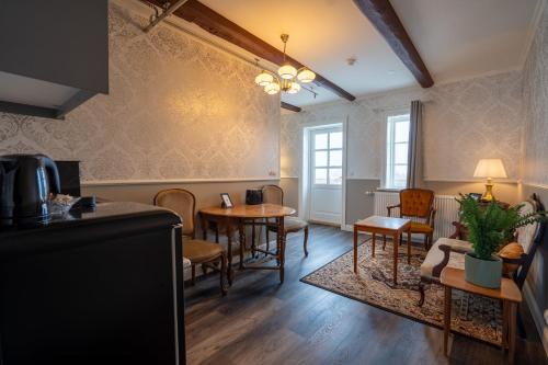 a living room with a table and chairs at Hótel Blönduós in Blönduós