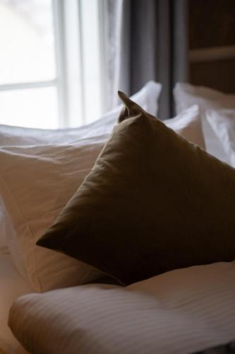 a pillow sitting on top of a bed at Hótel Blönduós in Blönduós