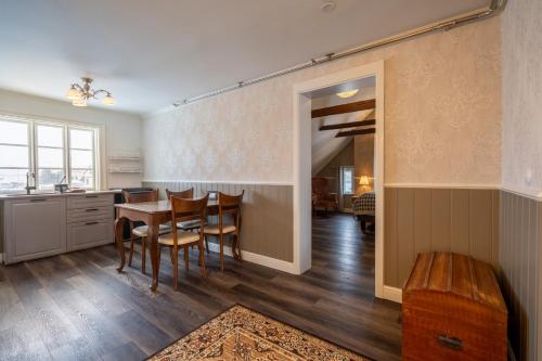 a kitchen and dining room with a table and chairs at Hótel Blönduós in Blönduós