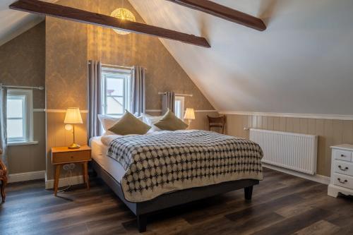 a bedroom with a bed and two windows at Hótel Blönduós in Blönduós