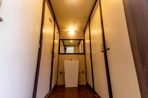 a hallway with two doors and a mirror at Social Safari Hostel, PARK STREET in Kolkata