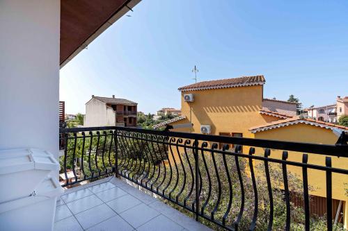 a balcony with a view of a city at Villa Elisabetta Apartments in Pula