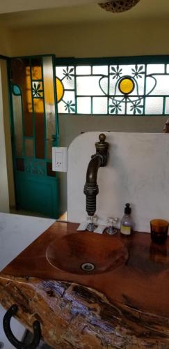 a bathroom with a wooden sink and a window at El Churqui in Cafayate