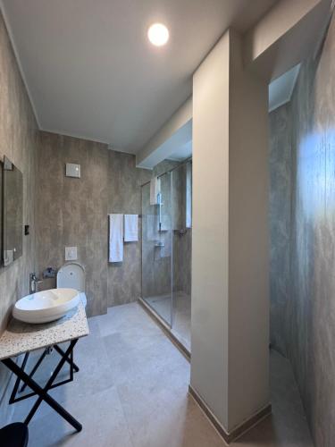 a bathroom with a sink and a shower at Hotel Eforie Nord in Eforie Nord