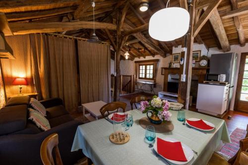 a living room with a table and a couch at Gite des granges in Fargues