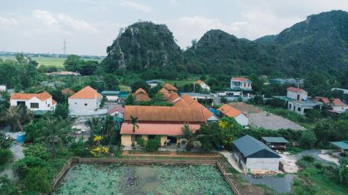 an aerial view of a village with mountains in the background at Amazing Ninh Binh Garden in Xuân Sơn