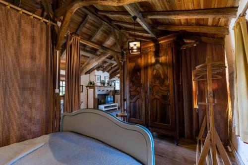 a bedroom with a bed in a room with wooden ceilings at Gite des granges in Fargues