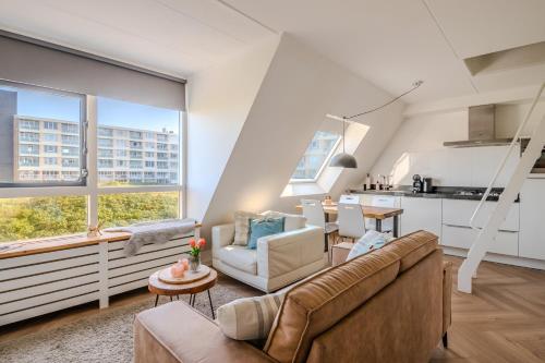 a living room with a couch and a table at Perfect Stay Holiday, Sea View in Egmond aan Zee