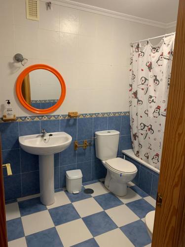 a bathroom with a sink and a toilet and a mirror at Apartamentos La Almadraba 1-5 in El Pozo del Cabo