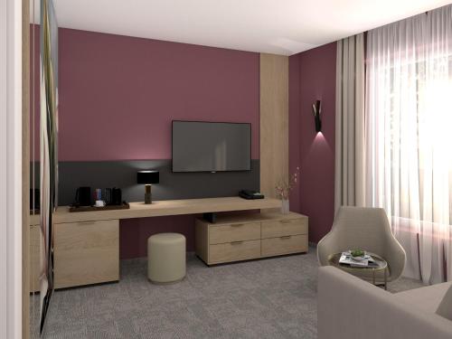 a living room with a tv on a purple wall at Energy Hotel & Business Center in Paks