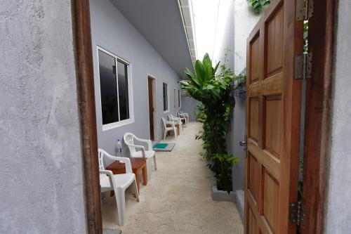 a hallway with chairs and tables in a building at Stay Kora in Thinadhoo
