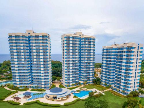 two tall buildings with a pool and a resort at Spacious Studio unit with Balcony and Seaview in Punta Engaño