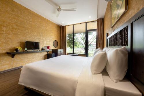 a bedroom with a large bed with white pillows at Amazing Ninh Binh Garden in Xuân Sơn