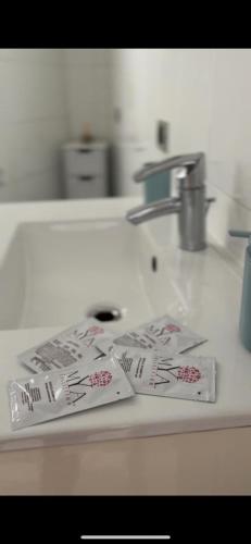 a kitchen counter with a sink with paper on it at Isa's house in Savona