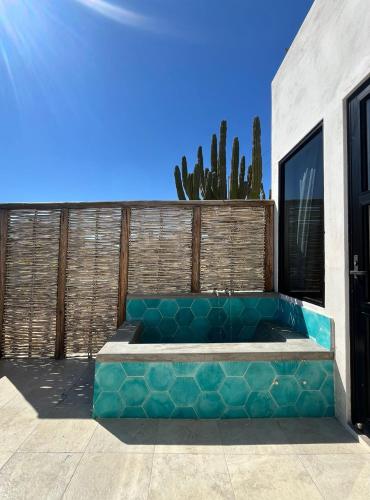a blue couch sitting in front of a building at La Ventana Hostel in La Ventana