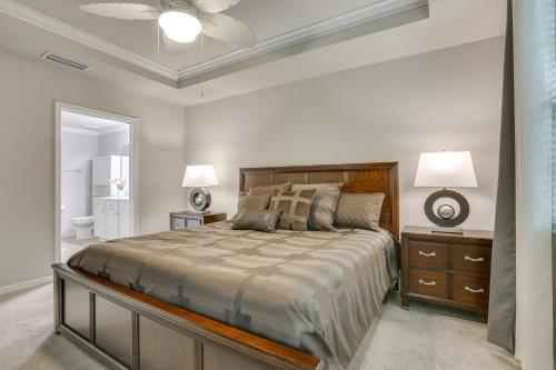 a bedroom with a bed and two lamps and a bathroom at Fort Myers Condo on 1st Floor Near Shops and Golf in Fort Myers