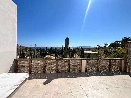 a balcony with a fence and cactus at La Ventana Hostel in La Ventana