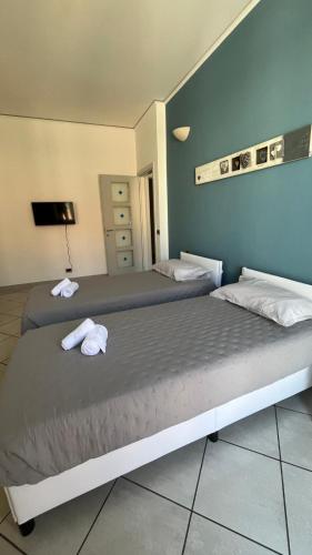 a bedroom with a bed with towels on it at Isa's house in Savona