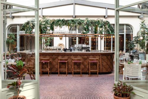 a bar in a restaurant with plants at Grands Boulevards Experimental in Paris