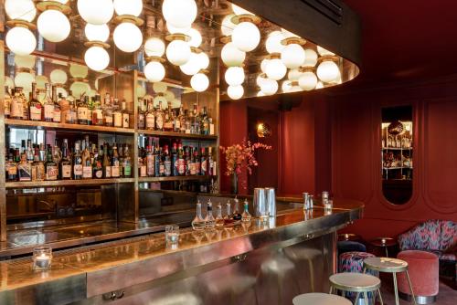 a bar with a lot of bottles of alcohol at Grands Boulevards Experimental in Paris