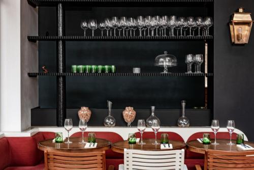 a restaurant with wooden tables and chairs and wine glasses at Grands Boulevards Experimental in Paris