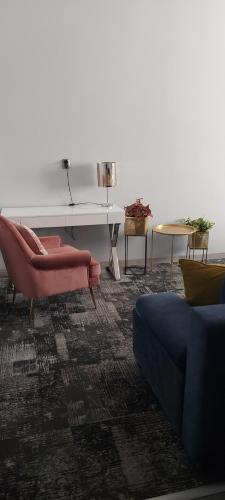 a living room with a couch and a table at Noclegi Gwardia in Koszalin