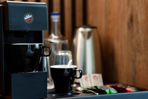 a coffee maker sitting on top of a counter at INFINITY Budapest Hotel in Budapest