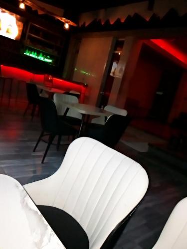 a white chair in a room with tables and chairs at Affta Inn in Addis Ababa