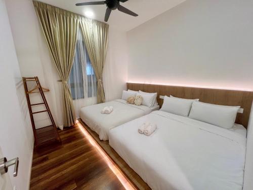 a bedroom with two beds with white sheets and a window at 2-8pax Ipoh Nomado Onsen suites by Sunway Onsen Lost world of Tambun in Ipoh