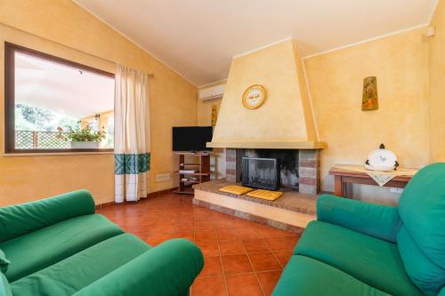 a living room with a couch and a fireplace at Casa Mameli in Quartucciu