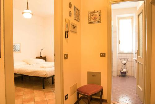 a room with a bed and a door leading to a bedroom at Villa Pini Balbiani - Appartamento Pini in Lierna