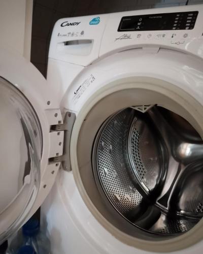 a white washing machine with its door open at Nähe Plohn Park - FEWO mit Spielzimmer und Balkon, DZ in Auerbach