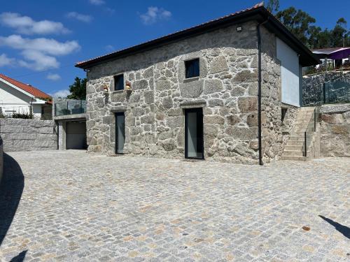 a stone house with a stone driveway at Cantinho Sto Amaro in Arcos de Valdevez