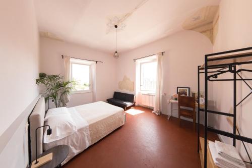 a bedroom with a bed and a couch in it at Aretium in Arezzo